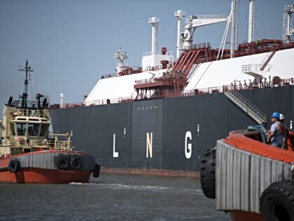 Tug boats prepare to pull out an LNG Tanker vessel at the Cheniere Sabine Pass Liquefactio