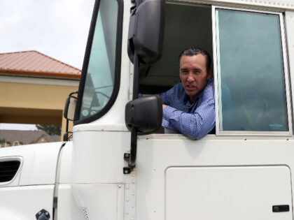 Pastor Tony Spell talks to the media as he drives a bus of congregants from Life Tabernacl
