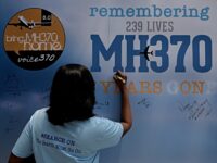 KUALA LUMPUR, MALAYSIA - MARCH 03: A family member writes on a message board for passenger