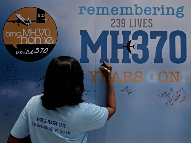 KUALA LUMPUR, MALAYSIA - MARCH 03: A family member writes on a message board for passenger