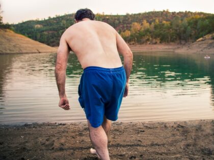 Man on shore of lake