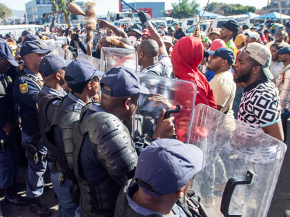 CAPE TOWN, SOUTH AFRICA - MAY 30: Public Order Police (POPS) prevent protestors from enter