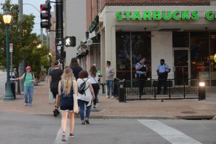 University City Police Officers stand outside a Starbucks prior to a protest action follow