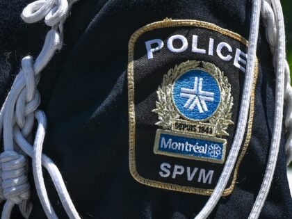 A police officer with a visible patch of the Montreal Police Service (SPVM Service de poli