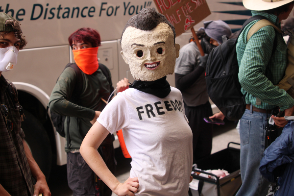 Protester wears mask outside hotel (1) (Randy Clark/Breitbart Texas)