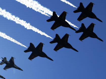 The U.S. Air Force Thunderbirds and U.S. Navy Blue Angels conduct a flyover on June 12, 20
