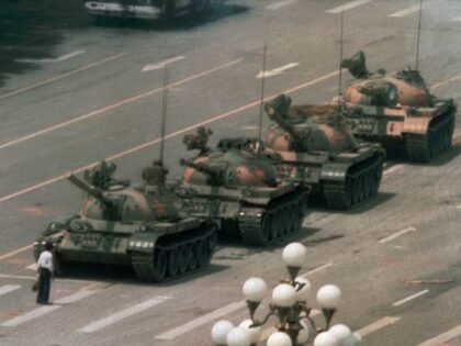 A Chinese man stands alone to block a line of tanks heading east on Beijing's Cangan
