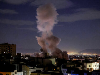 A smoke plume rises following a missile strike on a building in Tehran on March 1, 2026. T