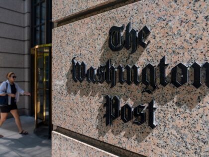 A person walks into the One Franklin Square Building, home of The Washington Post newspape