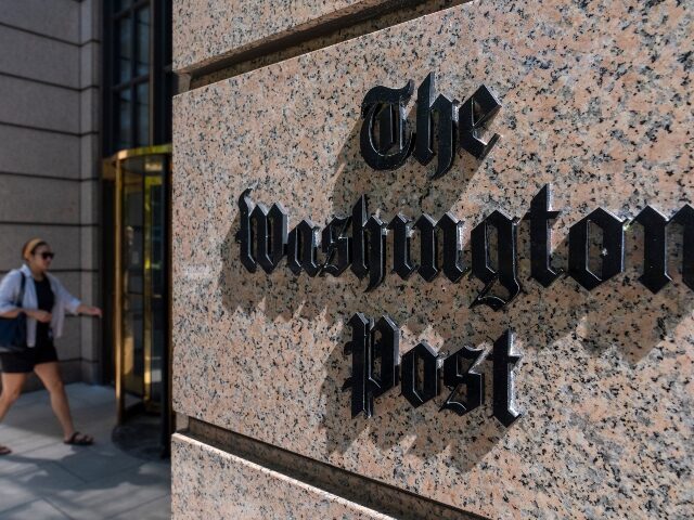 A person walks into the One Franklin Square Building, home of The Washington Post newspape