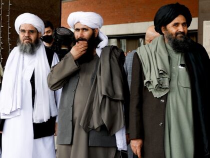 Taliban delegation headed by Abdul Ghani Baradar (R), the groups deputy leader, are seen l