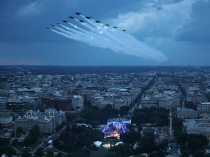U.S. Air Force Thunderbirds and the U.S. Navy Blue Angels perform a flyover during the Nat