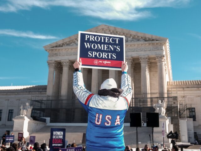 A demonstrator holds a sign outside the US Supreme Court in Washington, DC, US, on Tuesday
