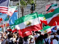 LOS ANGELES, CALIFORNIA - JUNE 15: Protestors demonstrate against the Islamic Republic of Iran, while holding pre-revolutionary Iranian flags and other flags, outside Los Angeles Stadium ahead of the Iranian national soccer team’s World Cup match against New Zealand on June 15, 2026 in Los Angeles, California. The FIFA ban on Iranian pre-revolution flags at the World Cup was upheld today following an emergency hearing. Iran is playing its first two matches in Los Angeles, whose metropolitan area is home to the largest Iranian population outside of Iran. (Photo by Mario Tama/Getty Images)