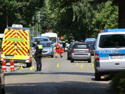 Police and rescuers work at the scene where five people were killed in a shooting in Stade