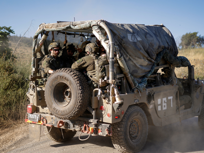 An Israeli army humvee vehicle patrols along the northern road near Moshav Margaliot in th