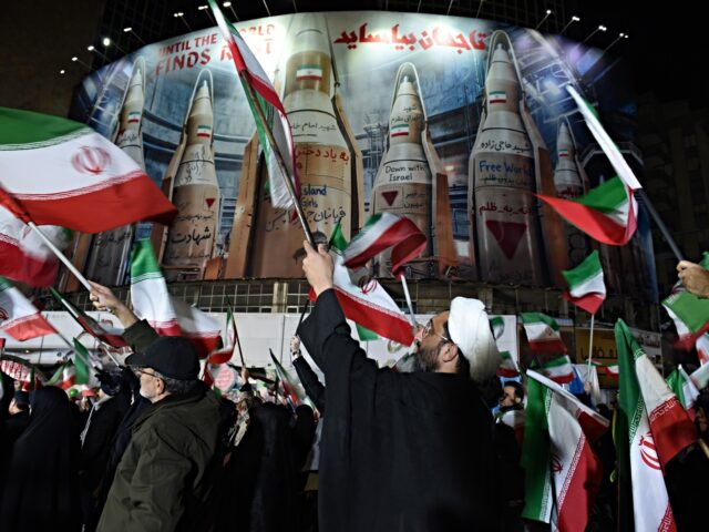 iran fires rockets Bahrain and Kuwait TEHRAN, IRAN - MARCH 17: A clergyman in turban holds an Iranian flag during a gathering to