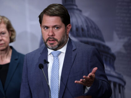 WASHINGTON, DC - JUNE 18: U.S. Sen. Tammy Baldwin (D-WI) (L) listens as Sen. Ruben Gallego