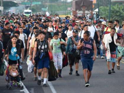 Migrants walk along the highway through Suchiate, Chiapas state in southern Mexico, Sunday