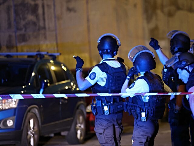 Monaco police officers patrol near the site of an explosion in a residential building in M