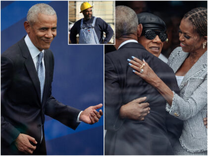 Former President Barack Obama plays air guitar along with Stevie Wonderâs performance at