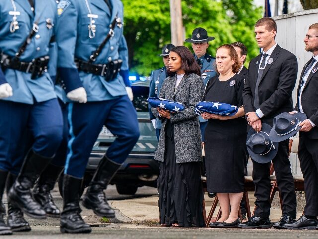 Salem, MA - May 13: Trooper Kevin Trainor's fiancée Jessica Ostrowski stands with Ke