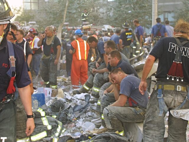 94277 01: New York City firefighters rest during rescue operations at the World Trade Cent