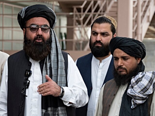 The Taliban government's deputy minister for refugees Mohammad Arsala Kharoti (C) speaks t