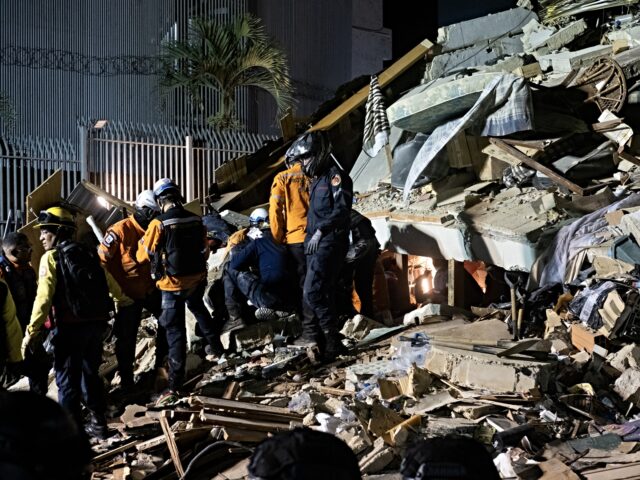 ARACAS, VENEZUELA - JUNE 24: Rescue workers search through the rubble of a collapsed build