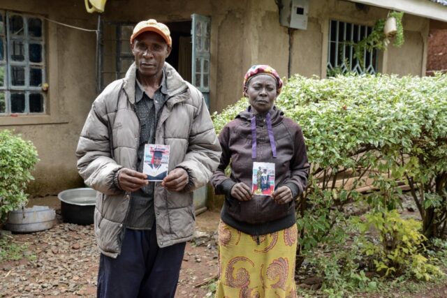 Moses Muyela and Josephine Ngoya hold photos of their son, who reportedly died in Ukraine