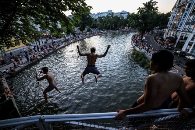 Parisians cooled off from the punishing heat in the capital's Canal Saint-Martin