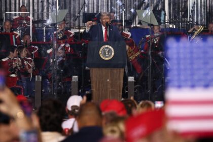 US President Donald Trump raises a fist as he speaks during the kick-off celebration for t