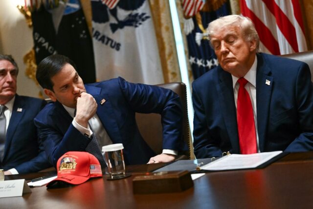 US Secretary of State Marco Rubio (center) and US President Donald Trump (right) listen du