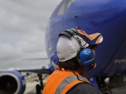 A ground operations employee wears a headset while preparing a Southwest Airlines Co. Boei