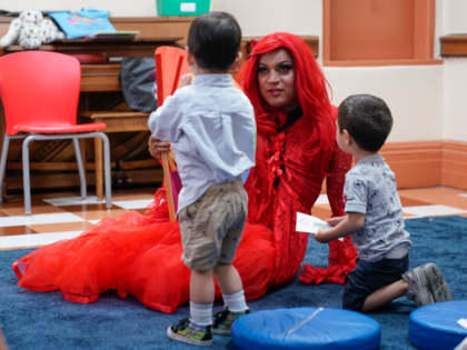 A drag queen who goes by the name Flame reads stories to children and their caretakers dur