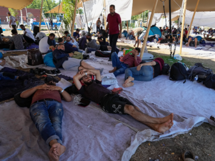 Hundreds of migrants seek shelter outside an overcrowded asylum seekers center in Ter Apel