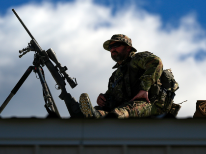 Law enforcement provides overwatch on a roof as supporters arrive before Republican presid