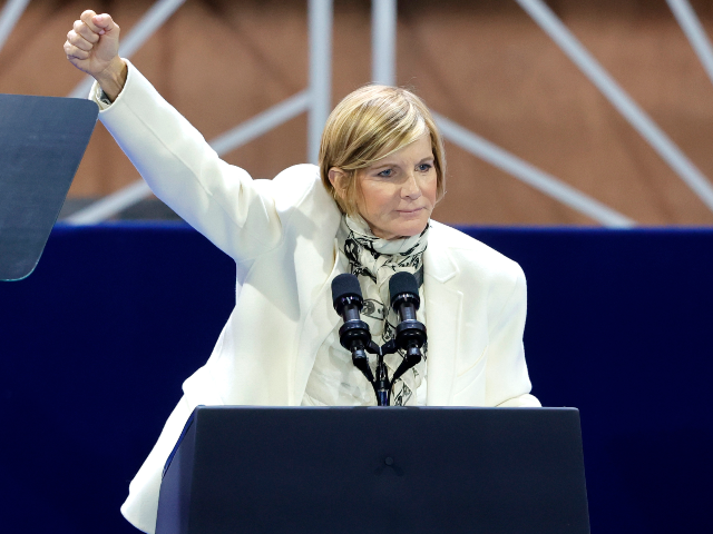 Rep. Susie Lee, D-Nev., raises a fist during a campaign rally for Democratic presidential