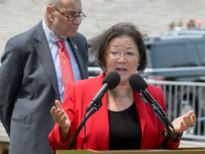 Sen. Mazie Hirono, D-Hawaii, speaks as Senate Minority Leader Chuck Schumer, D-N.Y., liste