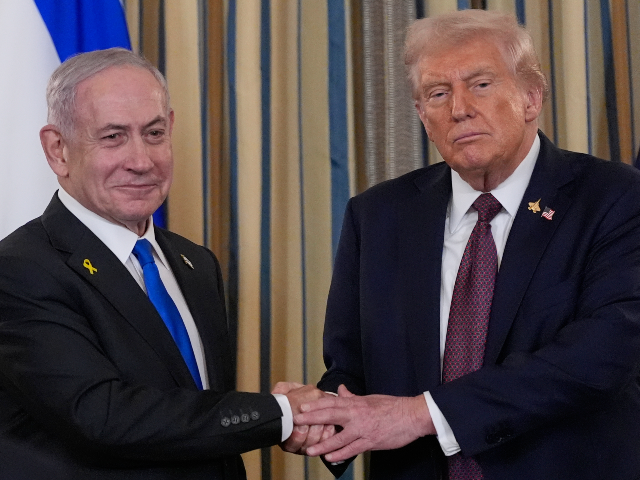 Israel's Prime Minister Benjamin Netanyahu shakes hands with President Donald Trump a