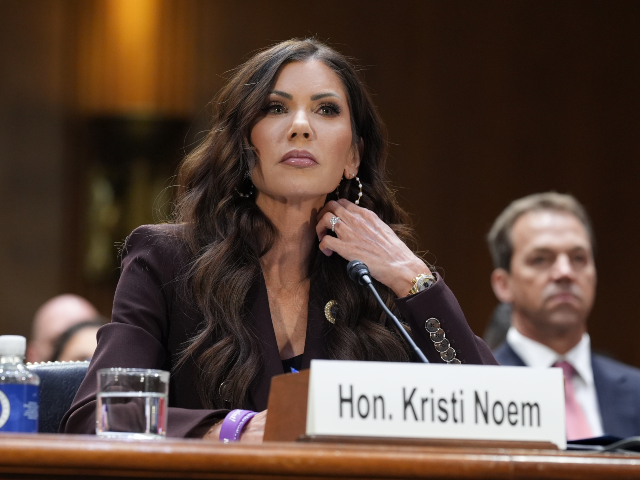 Homeland Security Secretary Kristi Noem, center, with her husband Bryon Noem, right, seate