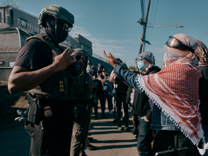 Protesters confront ICE agents outside the Delaney Hall detention center while demonstrati