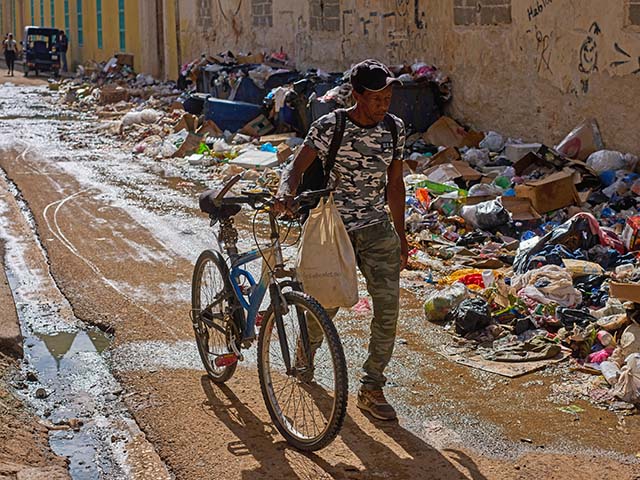 Title: Cuba Daily Life Image ID: 26160624082727 Article: A man pushes his bicycle along a trash-strewn street in Havana, Cuba, Tuesday, June 9, 2026. (AP Photo/Ramon Espinosa)