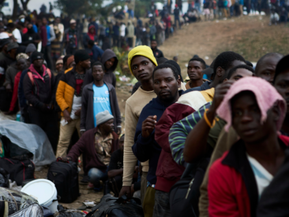 Displaced migrants queue at a deportation site, in Durban, South Africa, Wednesday, June 1