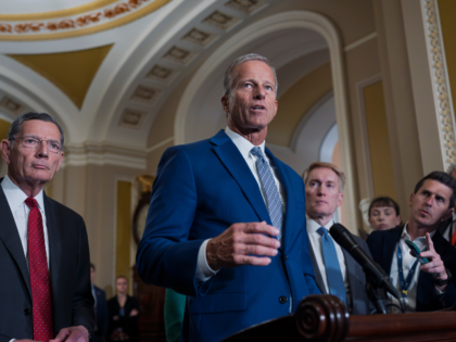 Senate Majority Leader John Thune, R-S.D., flanked by Sen. John Barrasso, R-Wyo., left, th