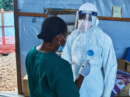 Title: Ebola Trials Image ID: 26185611765469 Article: Health workers interact at the Evang