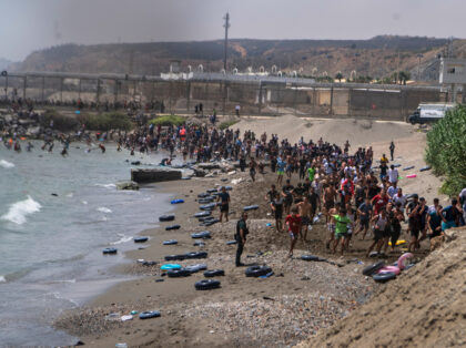 Migrants cross from Morocco into the Spanish enclave of Ceuta, Thursday, July 30, 2026. (A