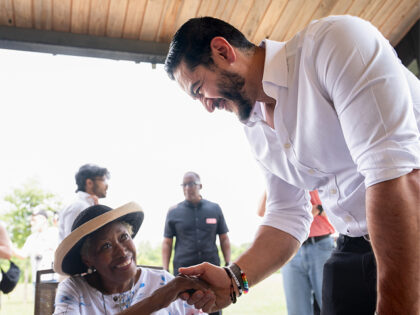 Abdul El-Sayed, US Democratic Senate candidate from Michigan, greets a resident at Rouge P
