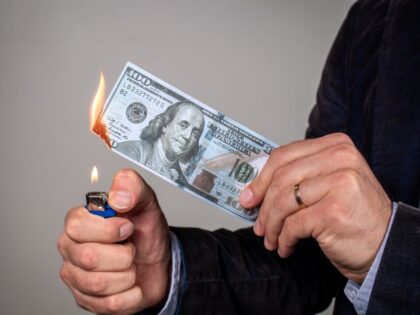 Business man burning money