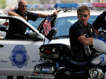 Members of the Denver Police Department watch as protesters and supports gathered to expre
